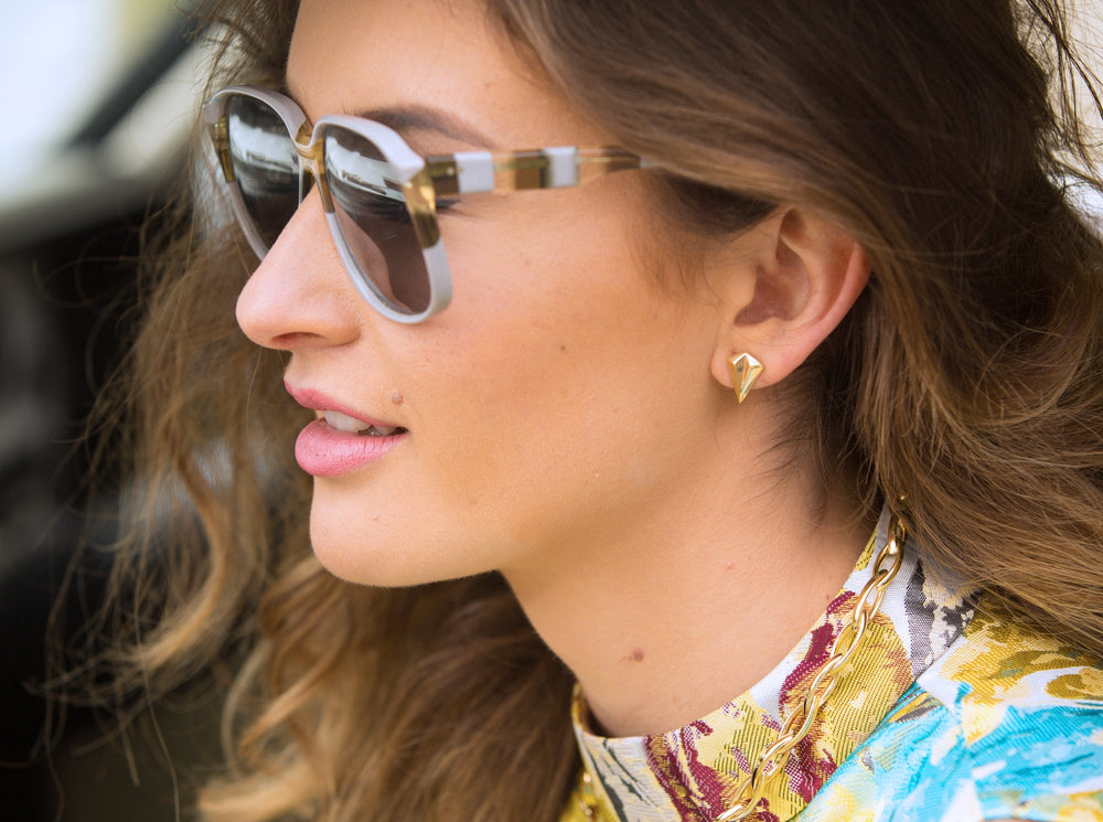 Look a million bucks - woman wearing earrings and sunglasses