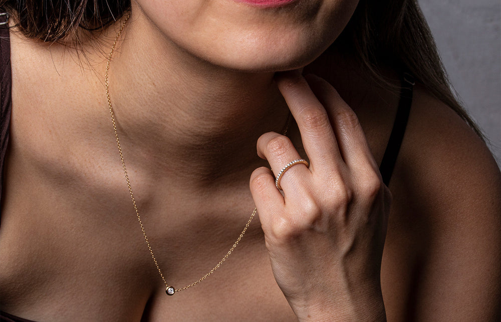 Model wearing diamond ring and pendant