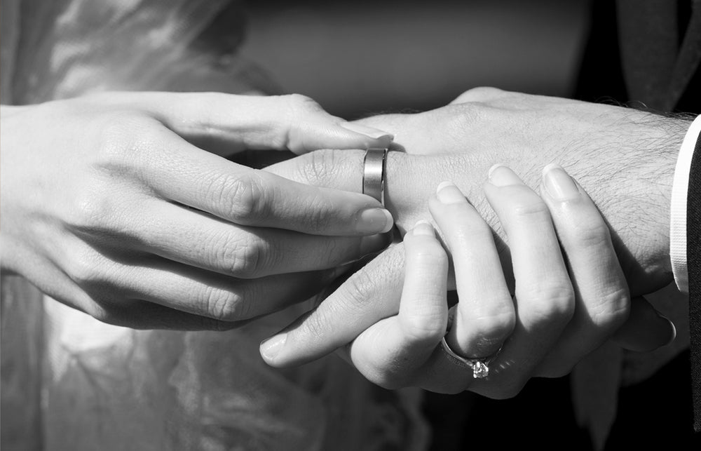 Couple exchanging wedding bands