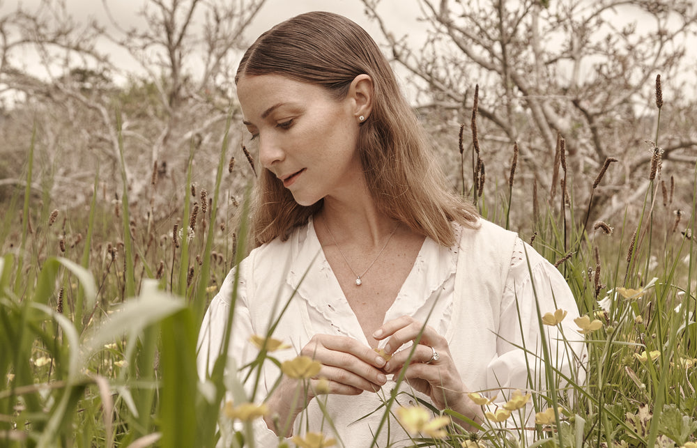 Model wearing Reclaimed diamond ring, pendant and earrings