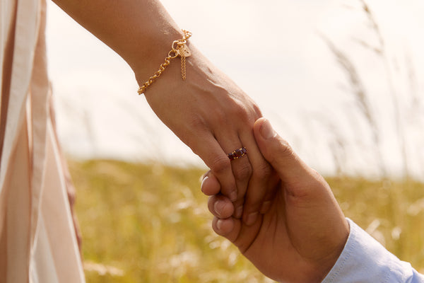 Couple holding hands, model wearing heart padlock bracelet