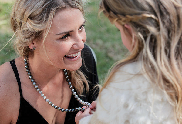 Daughter holding Mum's pearl strand