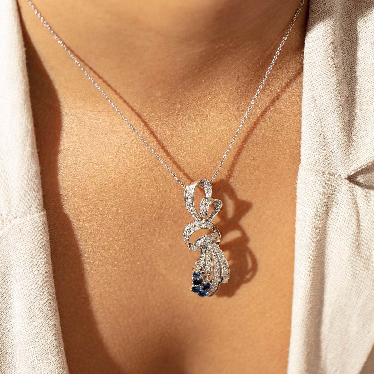Model wearing Evolved diamond and sapphire pendant