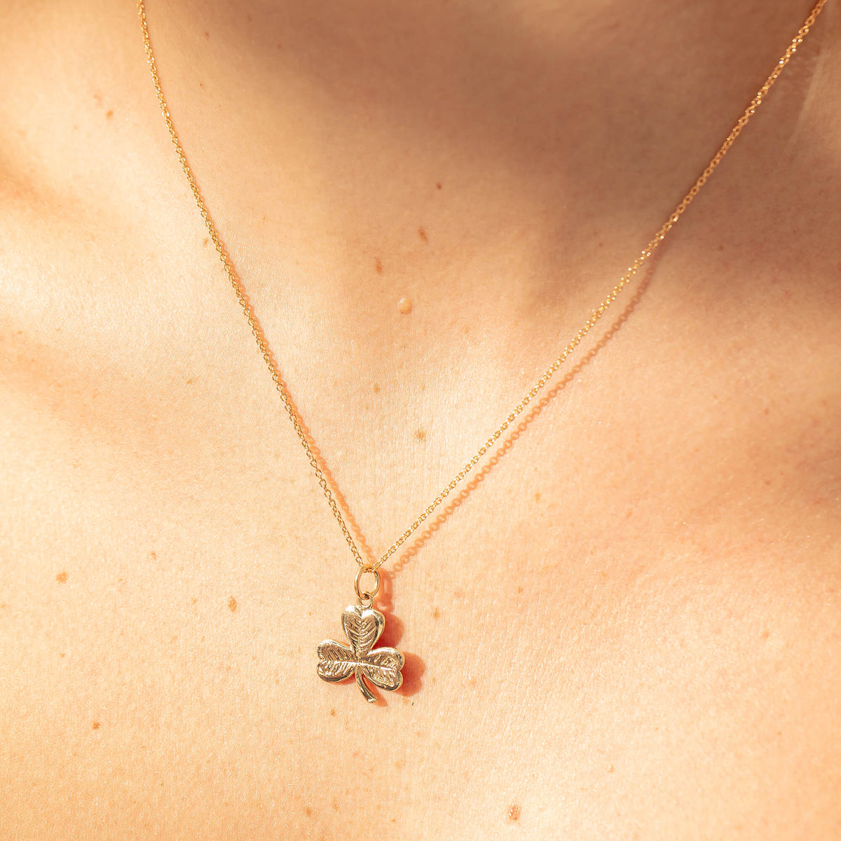 Model wearing Clover Charmed Necklace