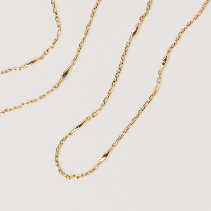 Gold Vesper Chain on neutral background