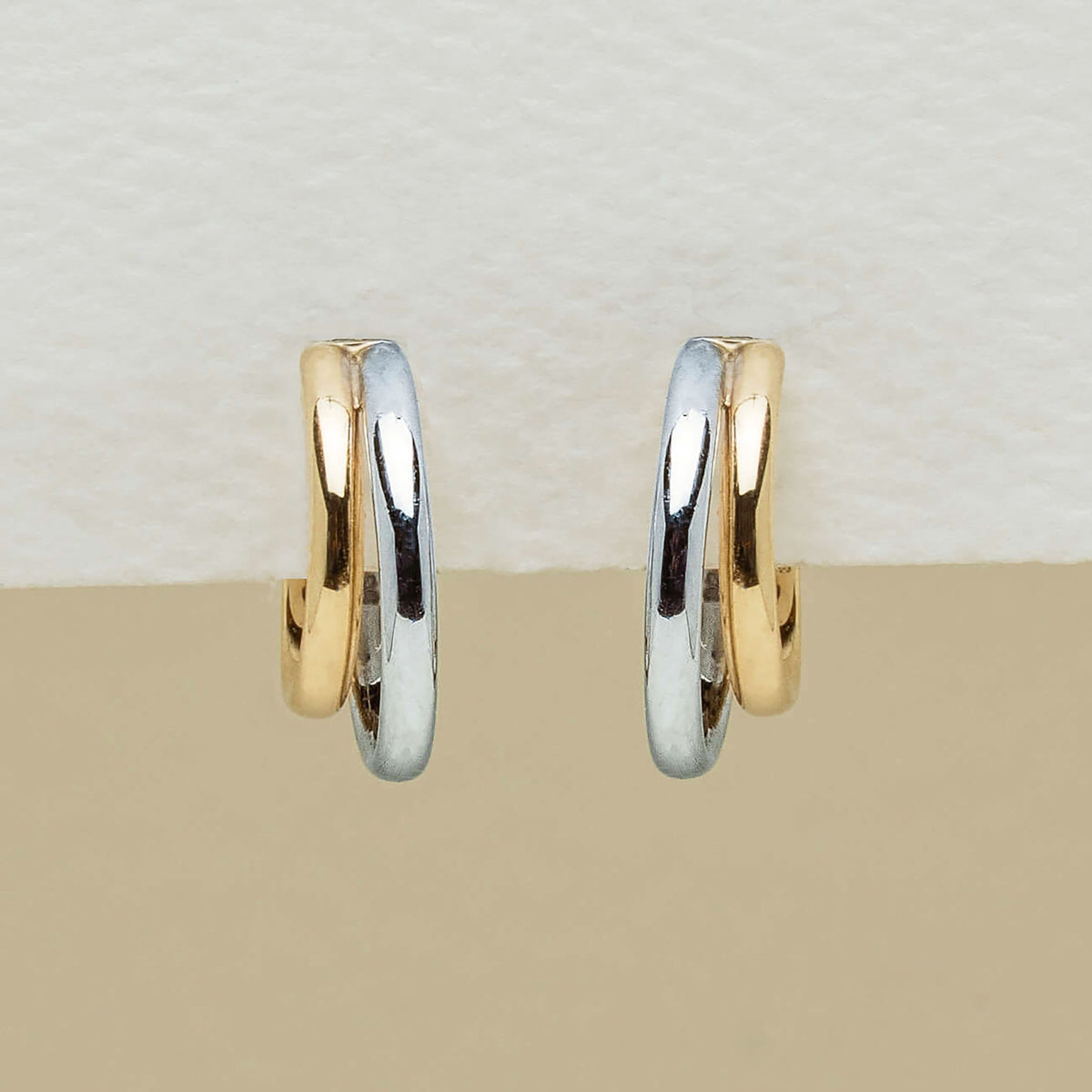 9ct yellow gold and sterling silver Gemma Earrings on neutral background