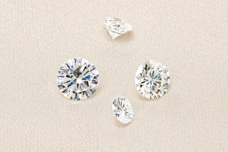 Loose round brilliant cut diamonds on a neutral background