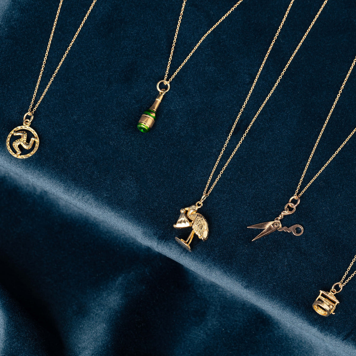 Selection of gold Charmed pendants on chains