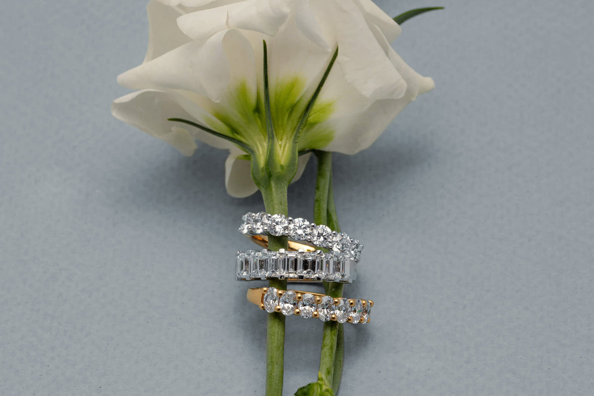 Three diamond bands on white rose stem
