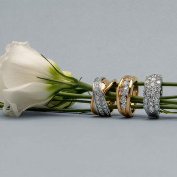 Three bold diamond bands on grey background with white rose