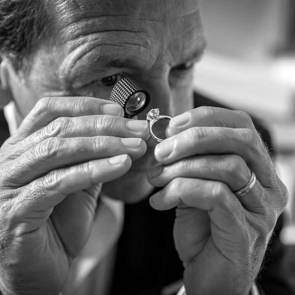 Walker & Hall Managing Director Joseph Tattersfield looking at a natural diamond ring through a loupe
