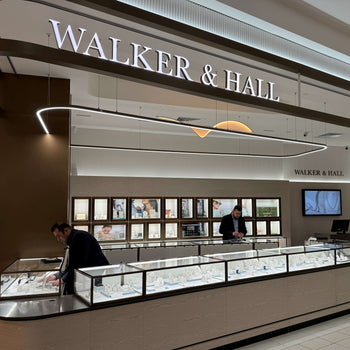 Walker & Hall store interior with display cases and people inside
