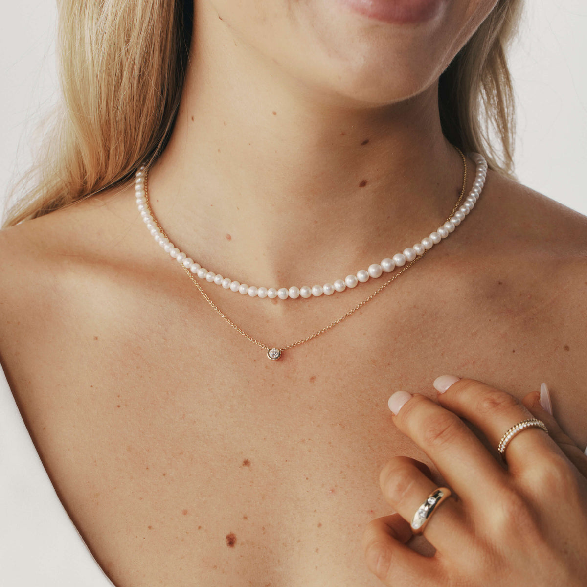 Model wearing natural diamond Natalia Pendant and pearl necklace