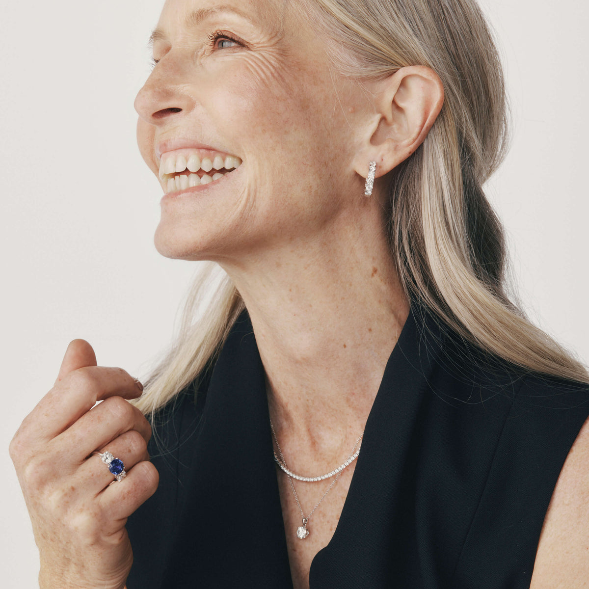 Model wearing diamond rings, necklace and earrings