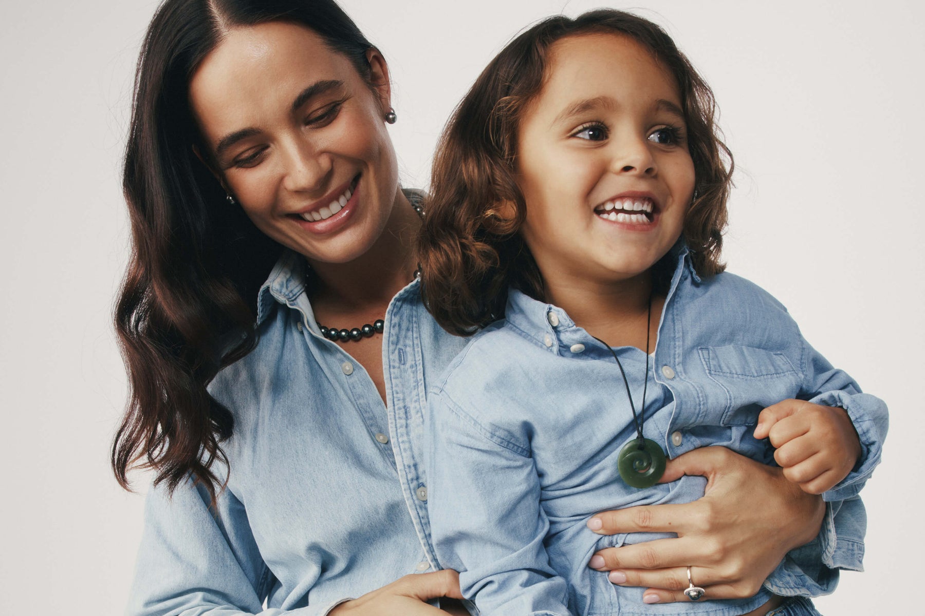 Mother and young son embracing, son wearing Greenstone Pounamu Pendant