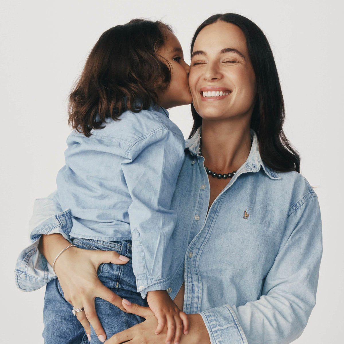 Young son kissing his Mum on her cheek