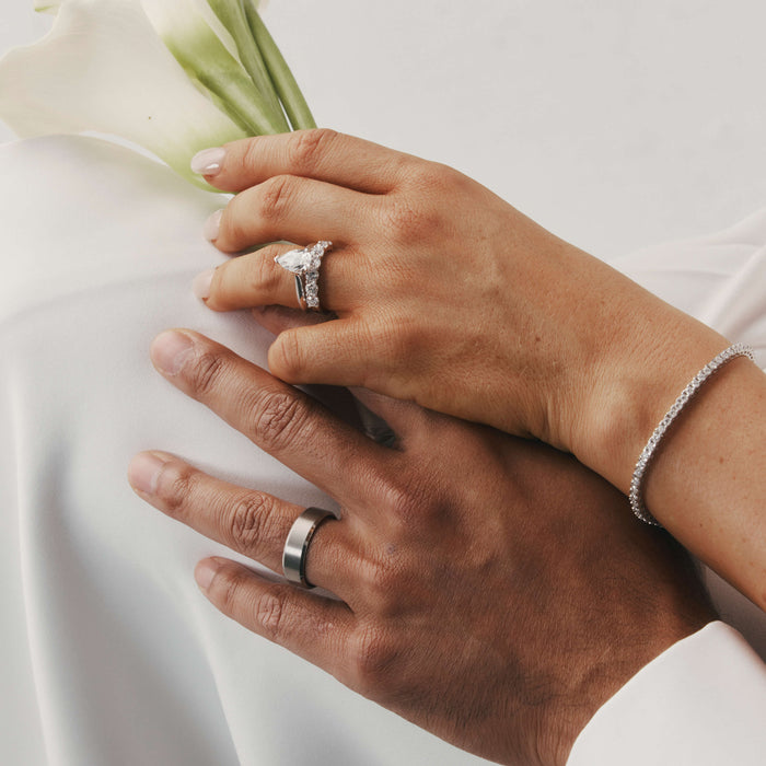 Bride and groom holding hands wearing Natural Diamond Engagement and Wedding Rings.