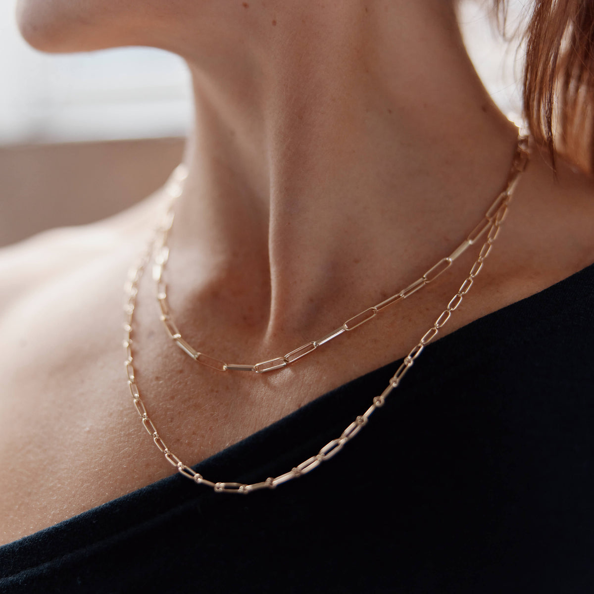 Model wearing recycled gold chains
