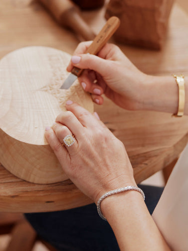 Artist Wanda Gillespie wood carving wearing Curated Collection pieces